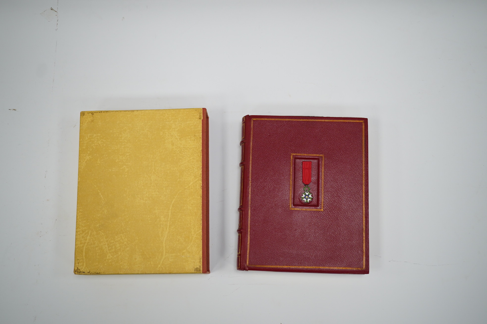 A framed medal group; Legion D'Honneur France, a British Cross, Italian order of Merit and Croix De Guerre with related book; La Legion d’Honneur by Jean Daniel, plus some related paperwork, three related medal miniature